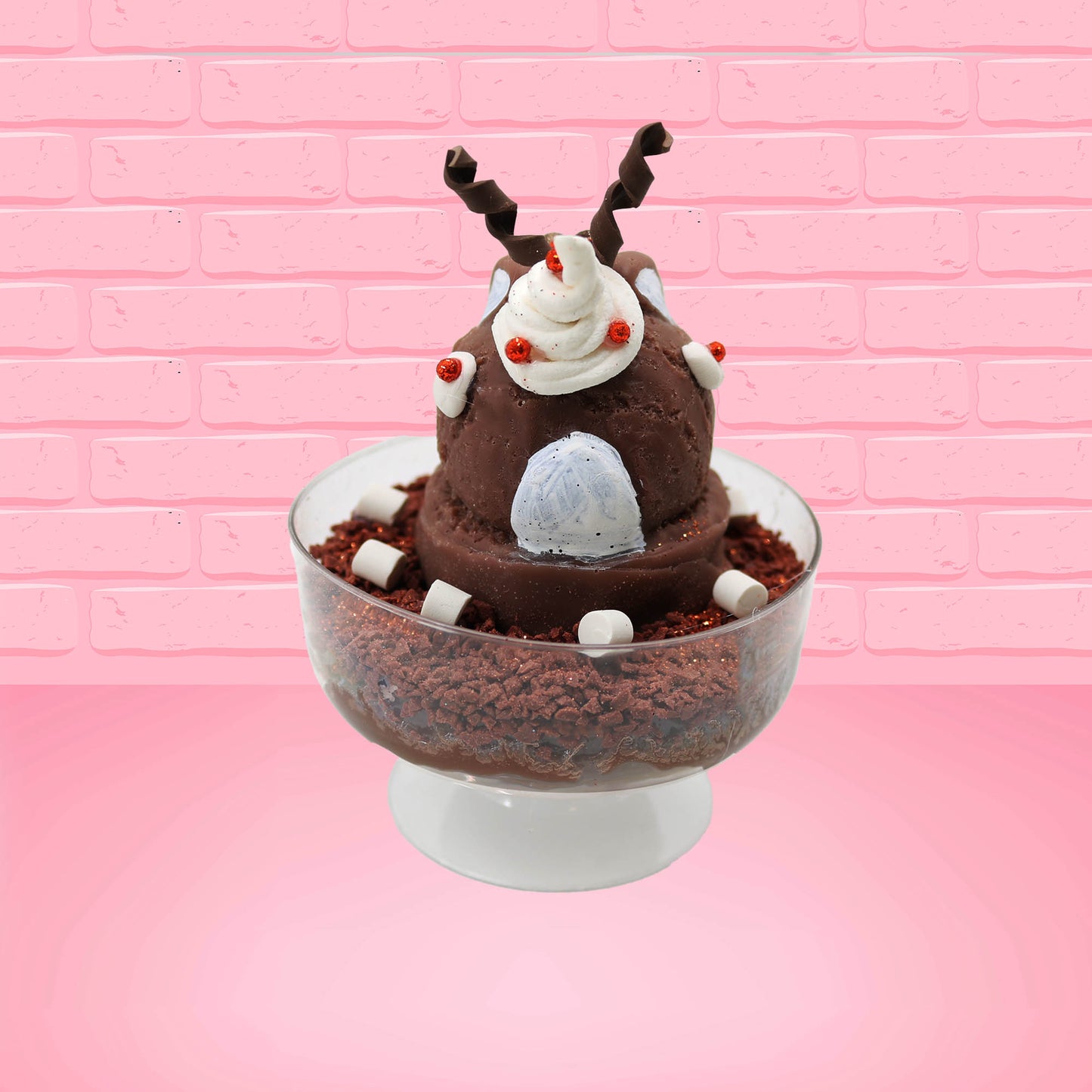 Cute kawaii bunny rocky on the rocks ice cream brown sundae with marshmallows and brown bits in the dish. The marshmallows on the top of the ice cream have red berries as well as two swirls of solid chocolate that stick up and a swirl of whipped cream is on the back. There are two chocolate balls and one red ball on between the ears of the ice cream bunny. This view is from the back.