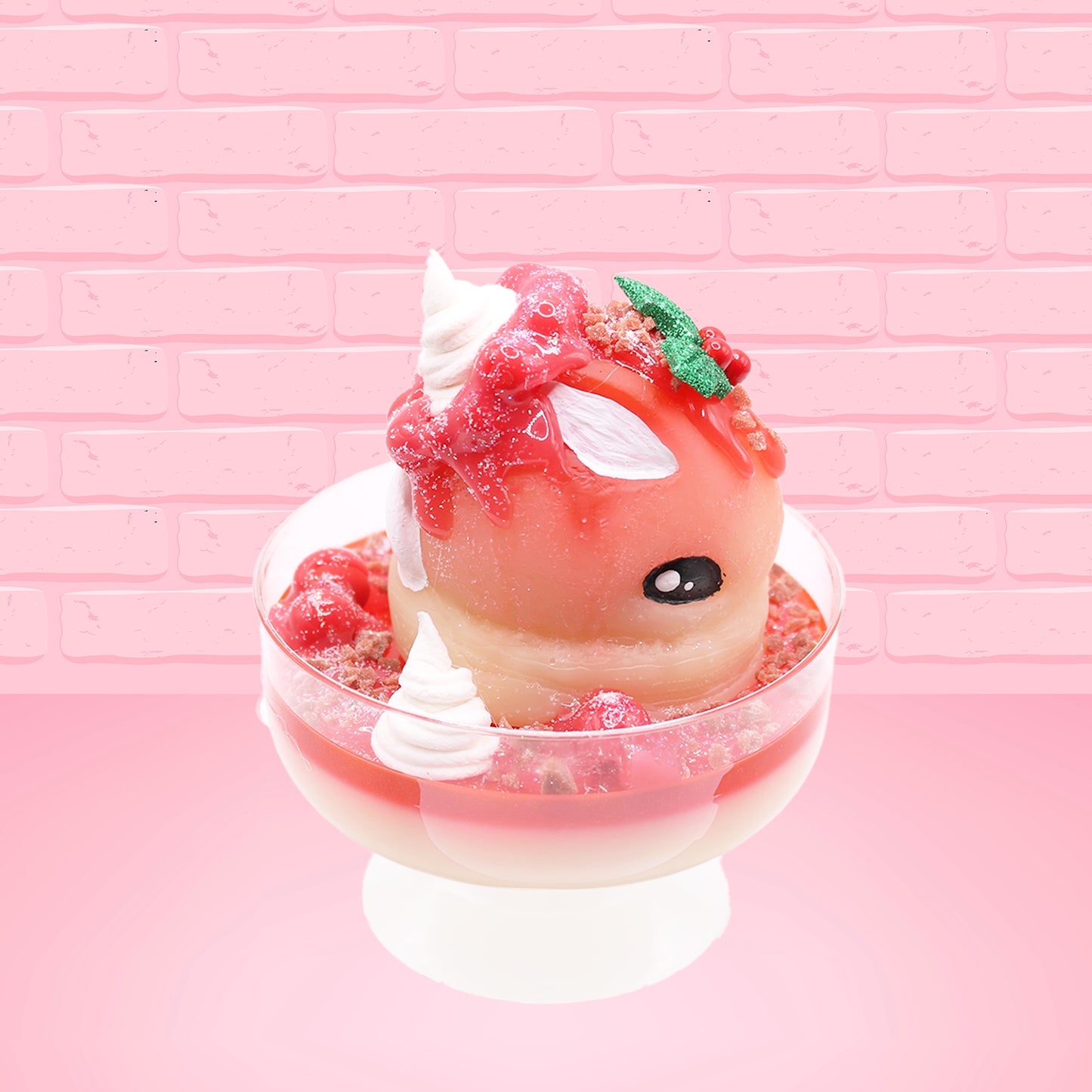 Cute kawaii bunny Santa Cookie Crumble white ice cream sundae with red glaze, glitter, red berries and whipped swirls in the dish. The bunny has red berries and green leaves on top with red translucent glaze near the whipped cream swirl. This view is from the side.
