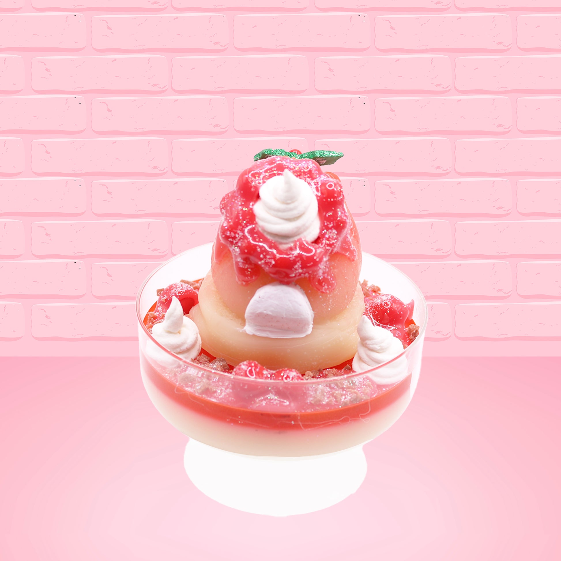 Cute kawaii bunny Santa Cookie Crumble white ice cream sundae with red glaze, glitter, red berries and whipped swirls in the dish. The bunny has red berries and green leaves on top with red translucent glaze near the whipped cream swirl. This view is from the back.