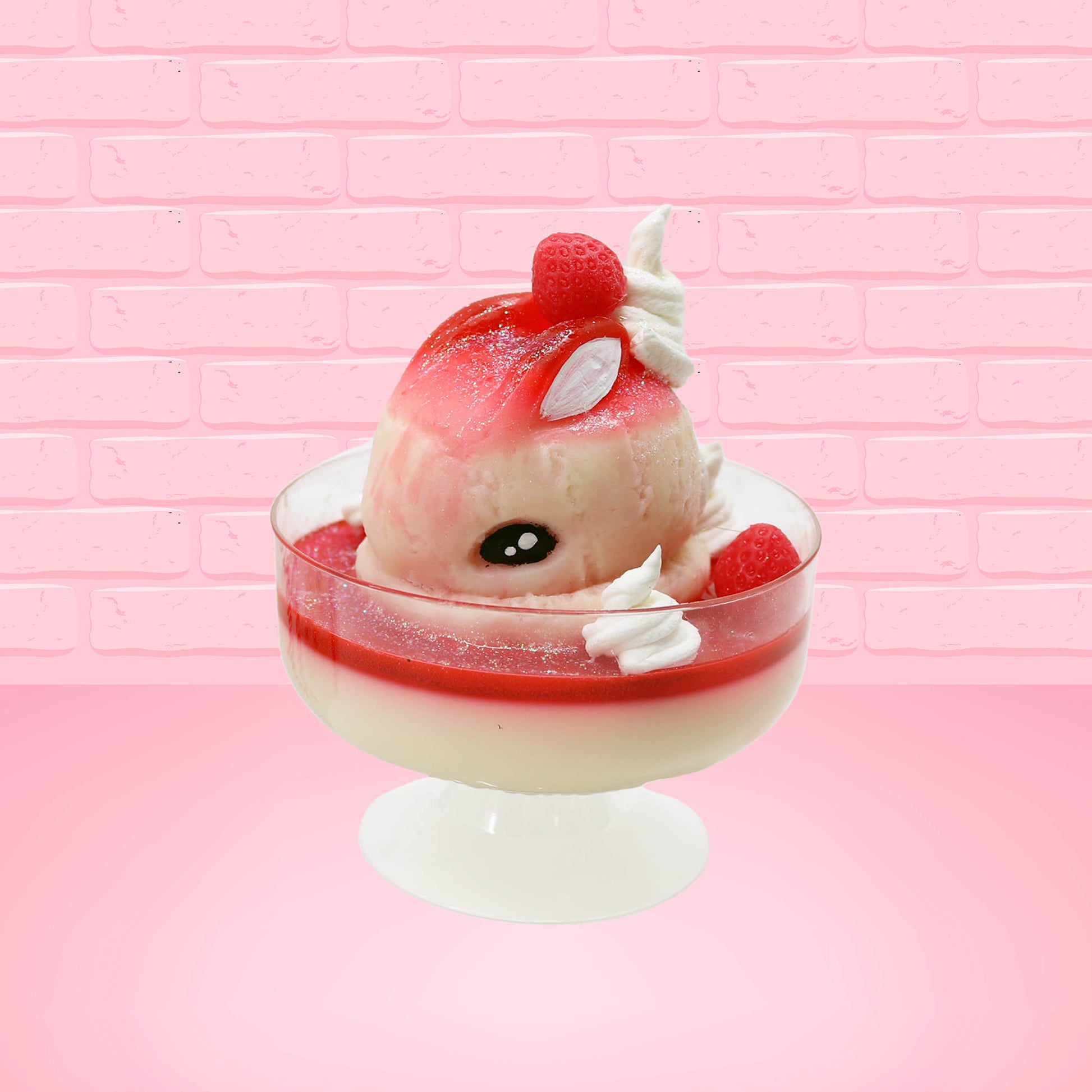 Cute kawaii bunny strawberry cheesecake white ice cream with red glaze, strawberries, and whipped cream swirls in the dish. The bunny has a strawberry on top between the ears, with a swirl of whipped cream on the back. This view is from the front at an angle.