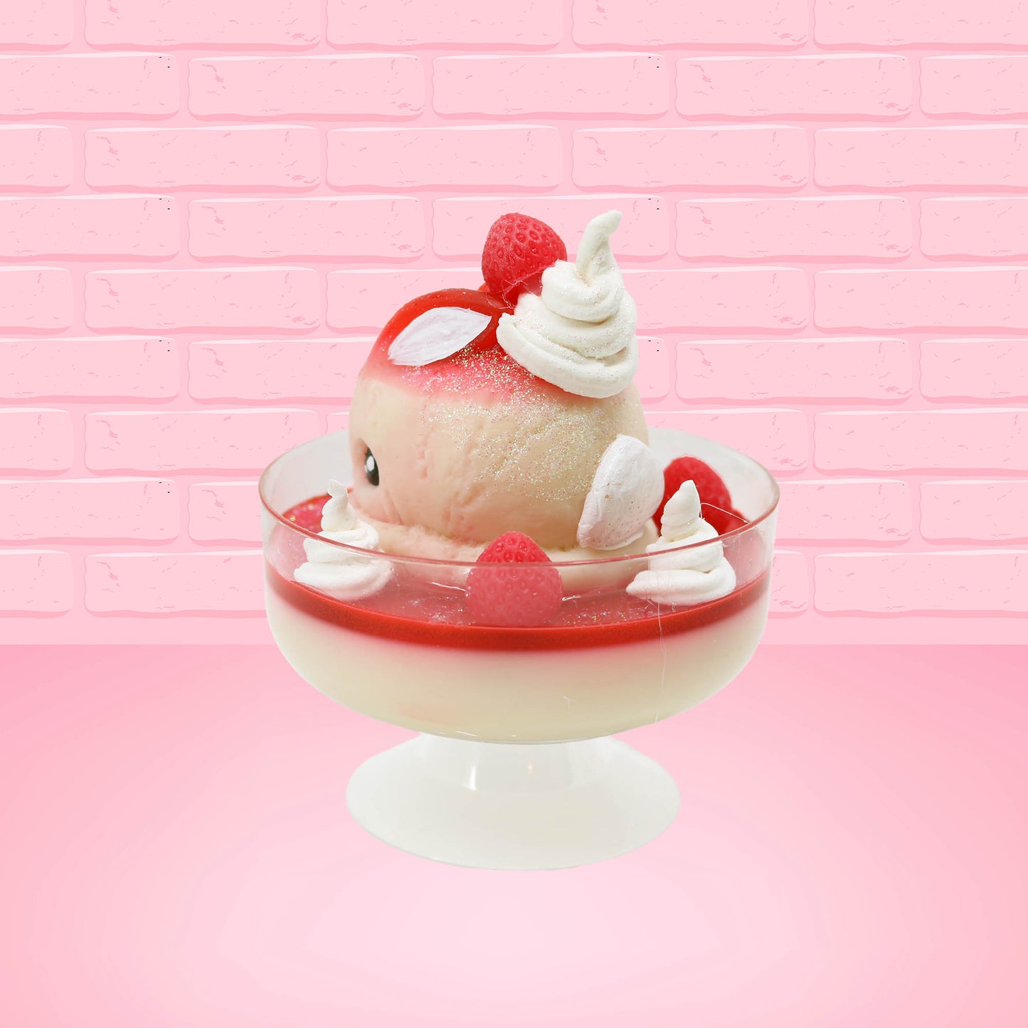 Cute kawaii bunny strawberry cheesecake white ice cream with red glaze, strawberries, and whipped cream swirls in the dish. The bunny has a strawberry on top between the ears, with a swirl of whipped cream on the back. This view is from the back at an angle.