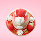 Cute kawaii bunny strawberry cheesecake white ice cream with red glaze, strawberries, and whipped cream swirls in the dish. The bunny has a strawberry on top between the ears, with a swirl of whipped cream on the back. This view is from the top.