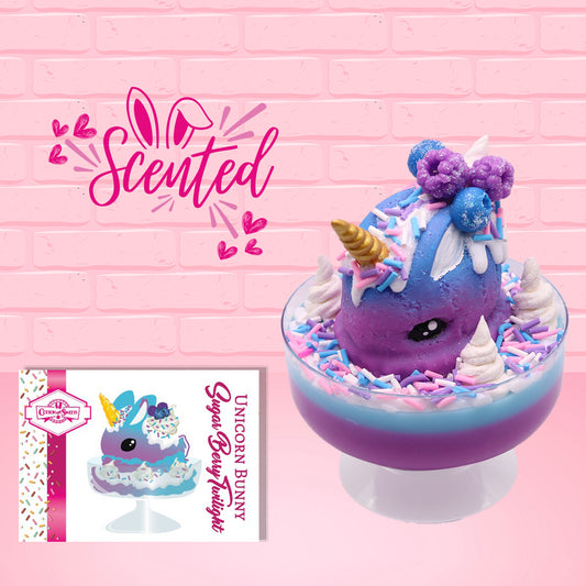 Cute kawaii unicorn bunny ice cream Sugar Berry Twilight sundae with whipped cream swirls, pink, blue, and white sprinkles in the dish. The unicorn bunny is purple and blue on top with blue berries and light purple raspberries, with a whipped cream swirl. The front of the character card is shown with the word scented.
