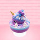 Cute kawaii unicorn bunny ice cream Sugar Berry Twilight sundae with whipped cream swirls, pink, blue, and white sprinkles in the dish. The unicorn bunny is purple and blue on top with blue berries and light purple raspberries, with a whipped cream swirl. This view is from the other side.