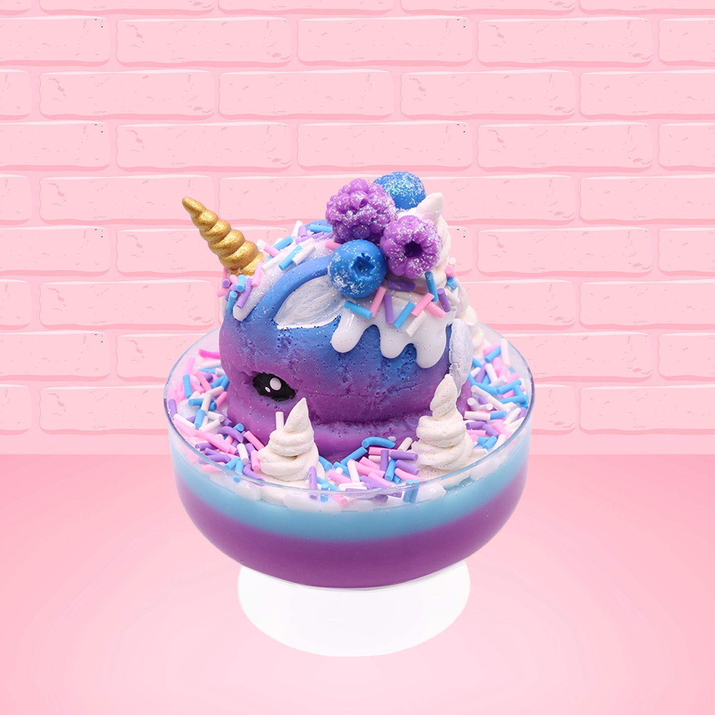 Cute kawaii unicorn bunny ice cream Sugar Berry Twilight sundae with whipped cream swirls, pink, blue, and white sprinkles in the dish. The unicorn bunny is purple and blue on top with blue berries and light purple raspberries, with a whipped cream swirl. This view is from the other side.