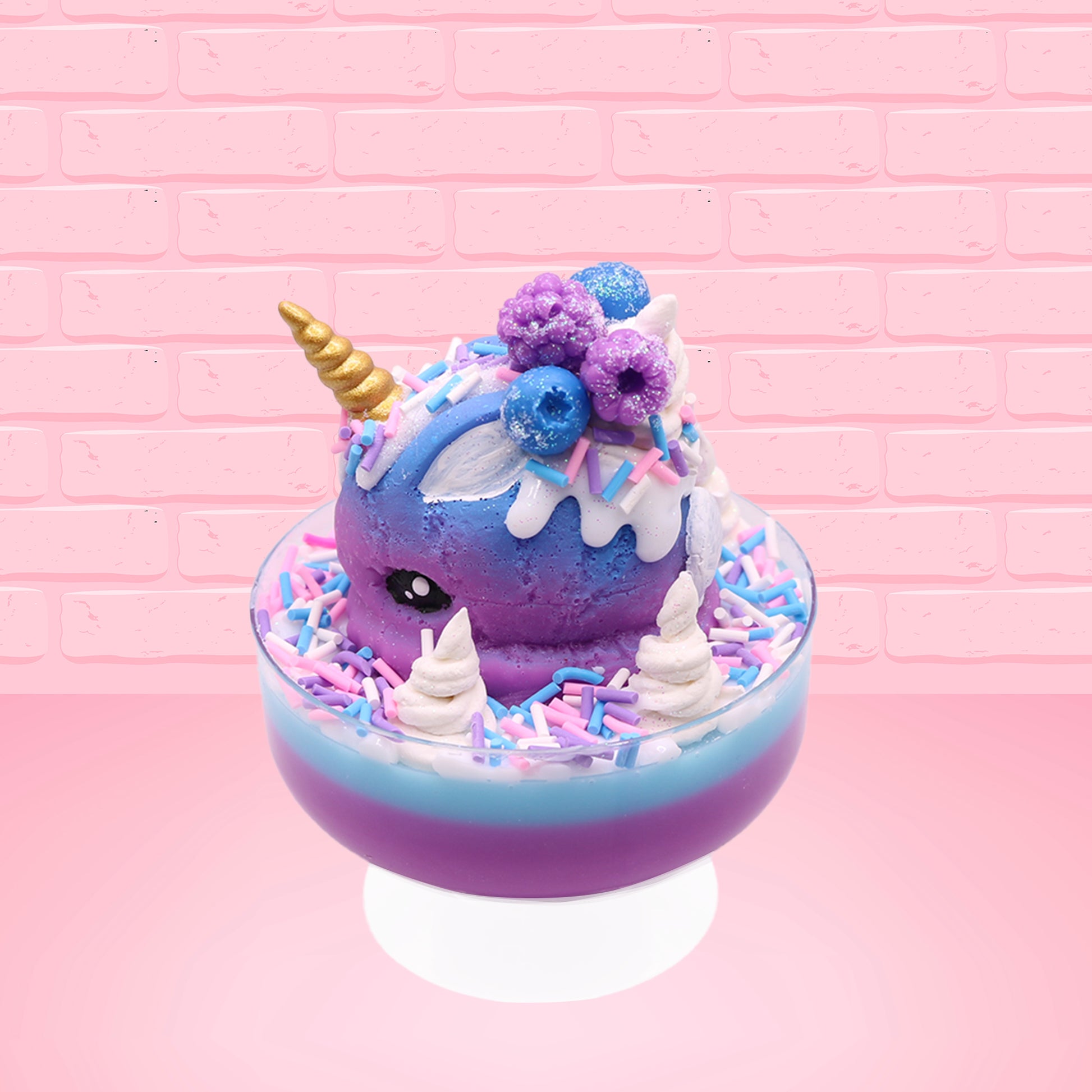 Cute kawaii unicorn bunny ice cream Sugar Berry Twilight sundae with whipped cream swirls, pink, blue, and white sprinkles in the dish. The unicorn bunny is purple and blue on top with blue berries and light purple raspberries, with a whipped cream swirl. This view is from the other side.