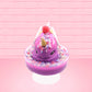 Cute kawaii unicorn purple and pink ice cream sundae with whipped cream swirls, purple, pink, white, and red star sprinkles in the dish. This unicorn bunny has white wings with a strawberry, banana slices and sprinkles on top near the whipped cream. This view is from the front.
