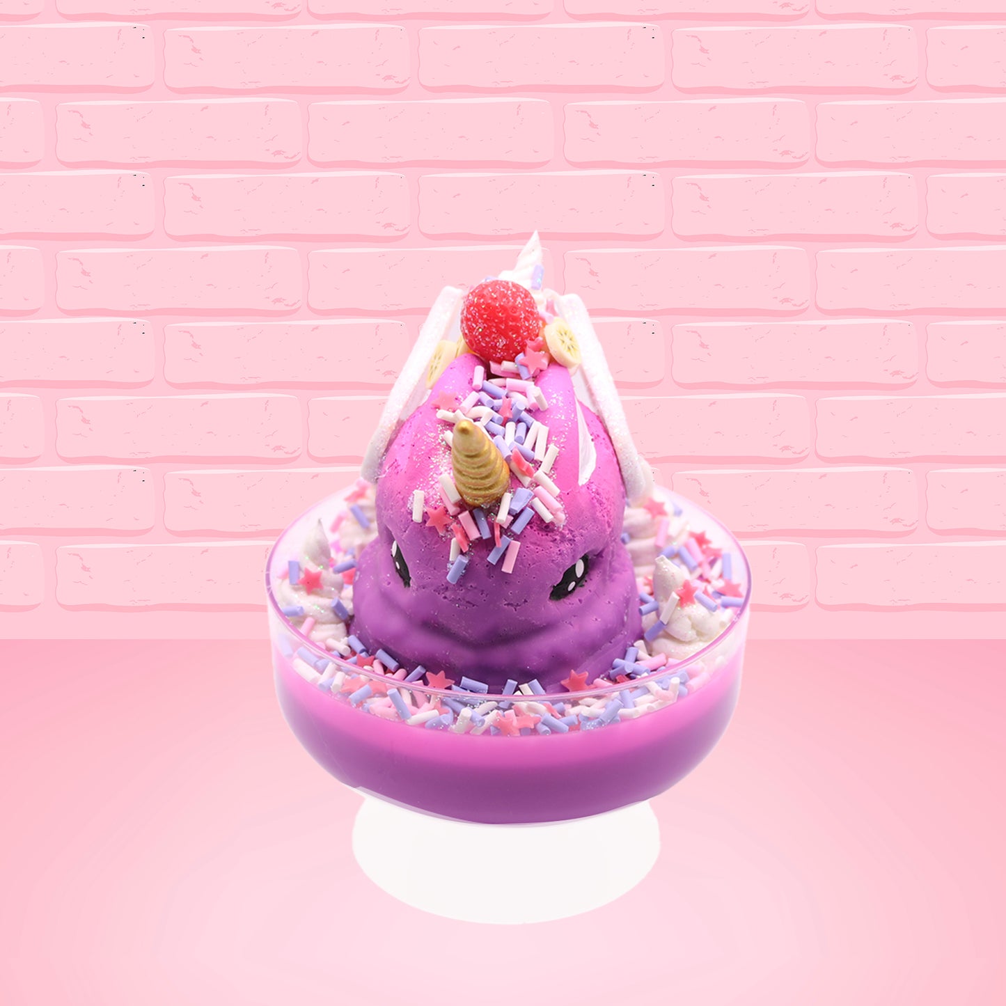 Cute kawaii unicorn purple and pink ice cream sundae with whipped cream swirls, purple, pink, white, and red star sprinkles in the dish. This unicorn bunny has white wings with a strawberry, banana slices and sprinkles on top near the whipped cream. This view is from the front.