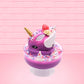 Cute kawaii unicorn purple and pink ice cream sundae with whipped cream swirls, purple, pink, white, and red star sprinkles in the dish. This unicorn bunny has white wings with a strawberry, banana slices and sprinkles on top near the whipped cream. This view is from the side.