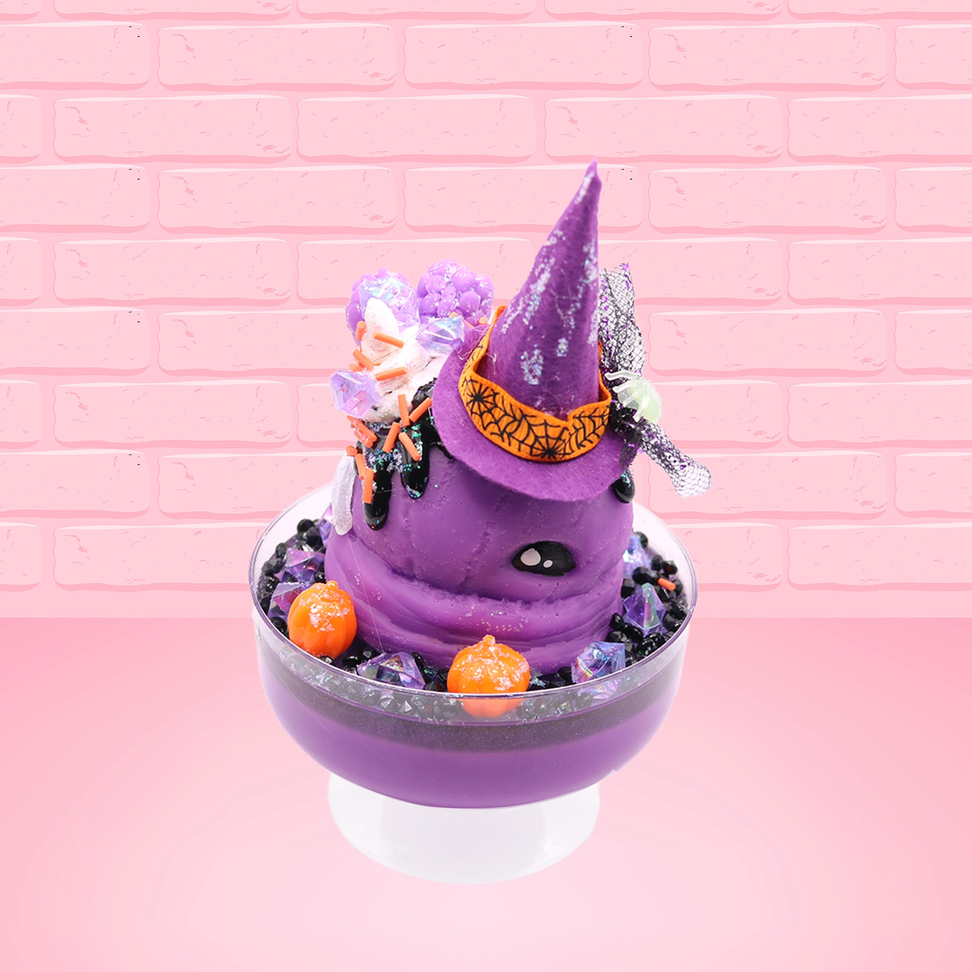 Cute kawaii witch bunny Blair purple ice cream with purple crystals and pumpkins on top of a layer of glittery black translucent layer. The bunny has a purple witch’s hat, with purple raspberries and a whipped cream swirl on top, with black glittery glaze and orange sprinkles. This view is from the side.