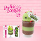 Cute kawaii bunny green Grinch Brownie tall sundae with brown sprinkles in the cup as well as a sign that reads don’t be a grinch. The ice cream bunny has peppermint candies, green and white sprinkles as well as a swirl of whipped cream on top.  The front of the character card is shown and the word scented. 
