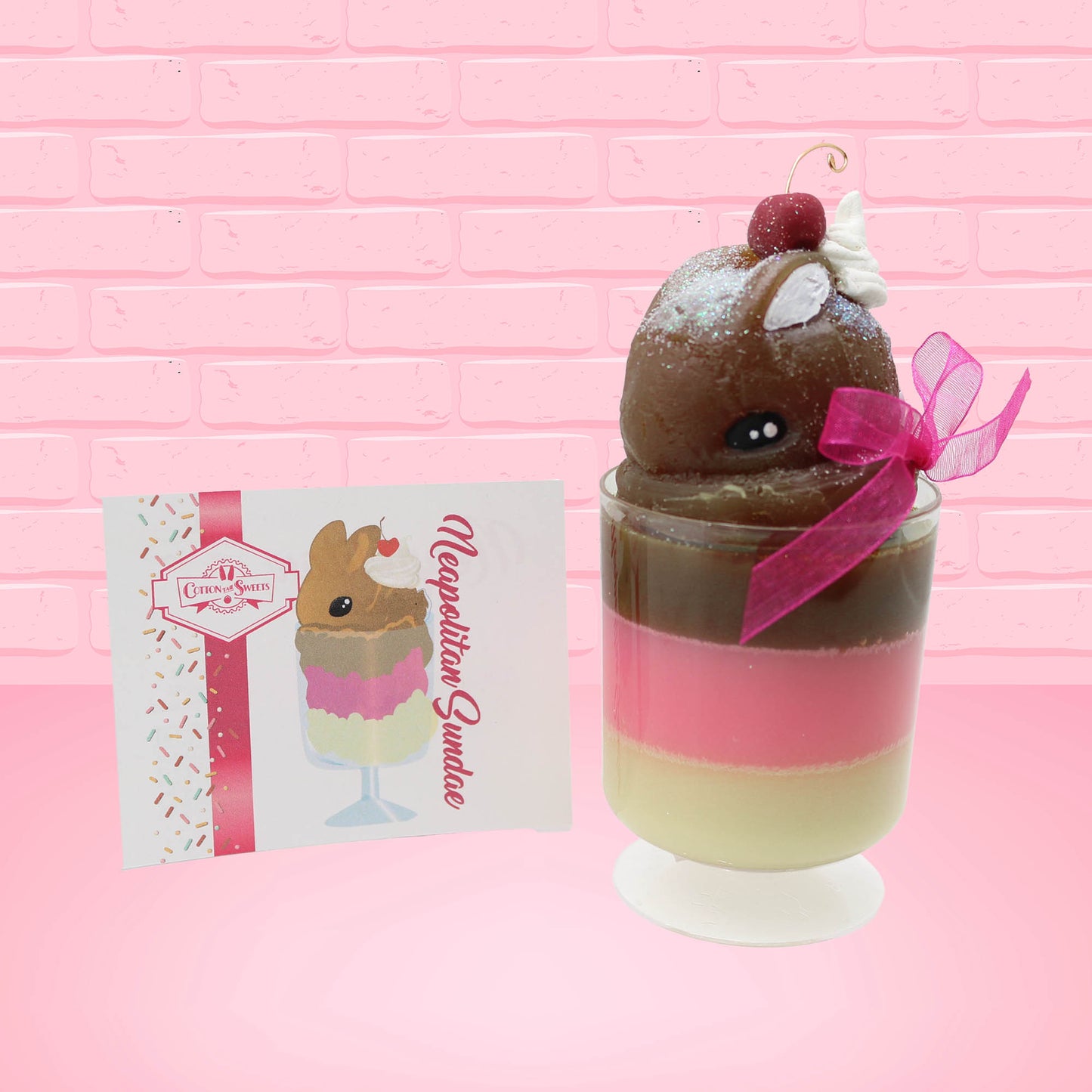 Cute Kawaii bunny tall Neapolitan three layered ice cream sundae with a cherry and swirl of whipped cream on top.  The top of the bunny is covered with white glitter, and has a pink bow.  The front of the character card is shown.