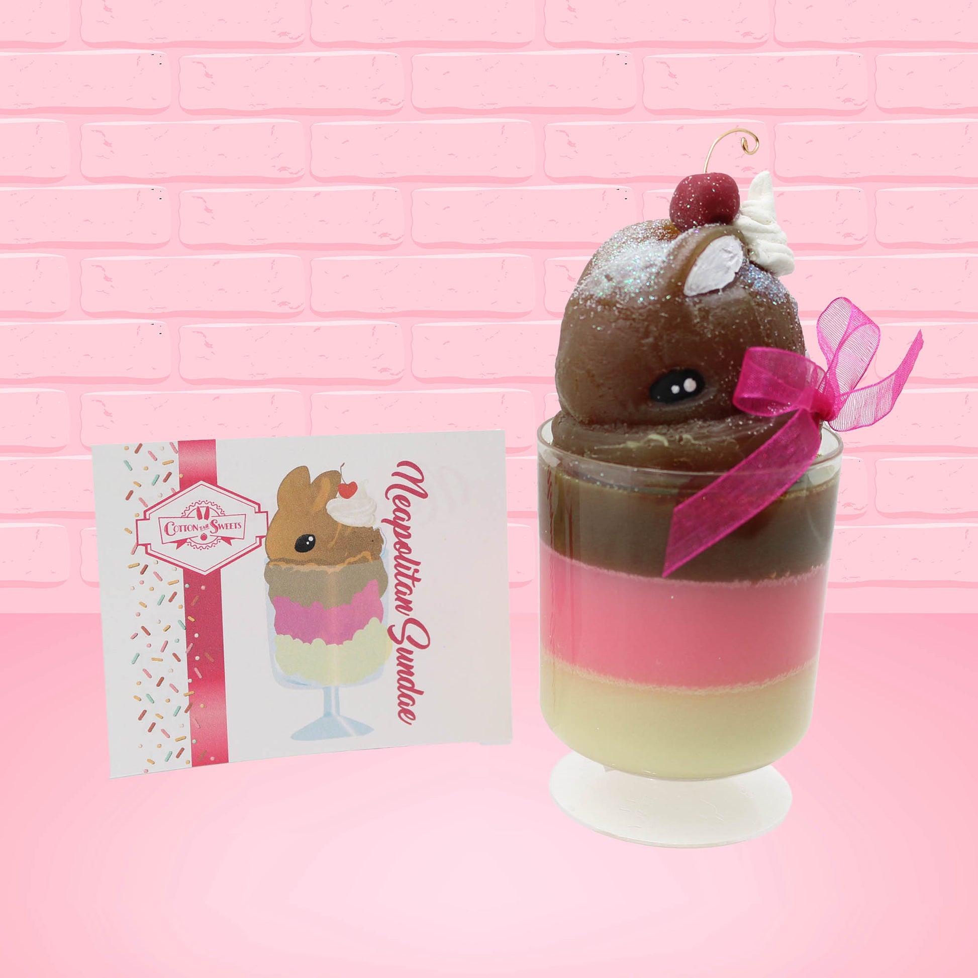 Cute Kawaii bunny tall Neapolitan three layered ice cream sundae with a cherry and swirl of whipped cream on top.  The top of the bunny is covered with white glitter, and has a pink bow.  The front of the character card is shown.