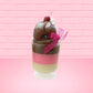 Cute Kawaii bunny tall Neapolitan three layered ice cream sundae with a cherry and swirl of whipped cream on top.  The top of the bunny is covered with white glitter, and has a pink bow.  This view is from the front at an angle.