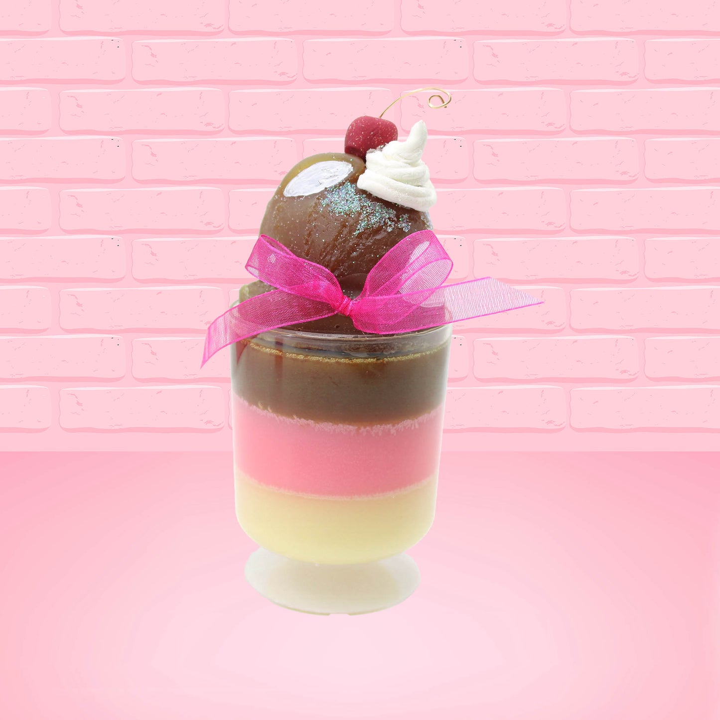 Cute Kawaii bunny tall Neapolitan three layered ice cream sundae with a cherry and swirl of whipped cream on top.  The top of the bunny is covered with white glitter, and has a pink bow.  This view is from the side.