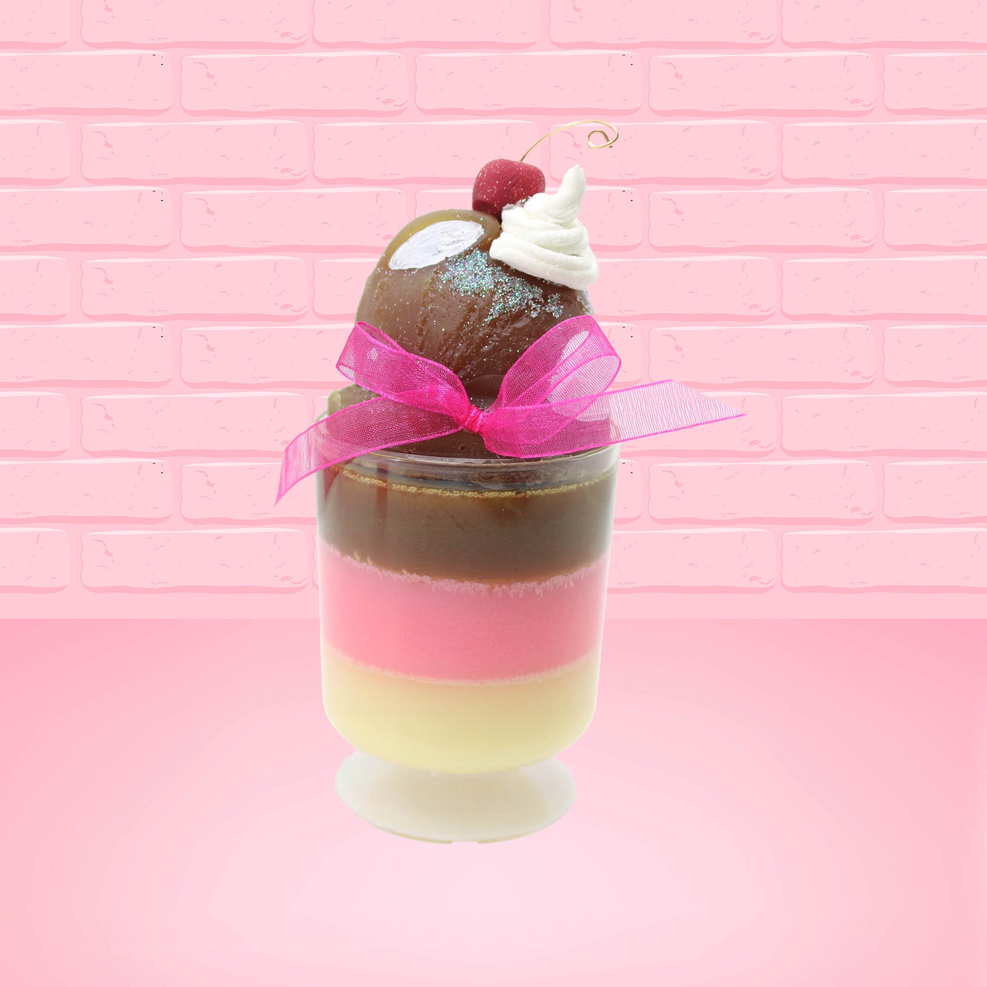 Cute Kawaii bunny tall Neapolitan three layered ice cream sundae with a cherry and swirl of whipped cream on top.  The top of the bunny is covered with white glitter, and has a pink bow.  This view is from the side.