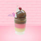 Cute Kawaii bunny tall Neapolitan three layered ice cream sundae with a cherry and swirl of whipped cream on top.  The top of the bunny is covered with white glitter, and has a pink bow.  This view is from the other side.