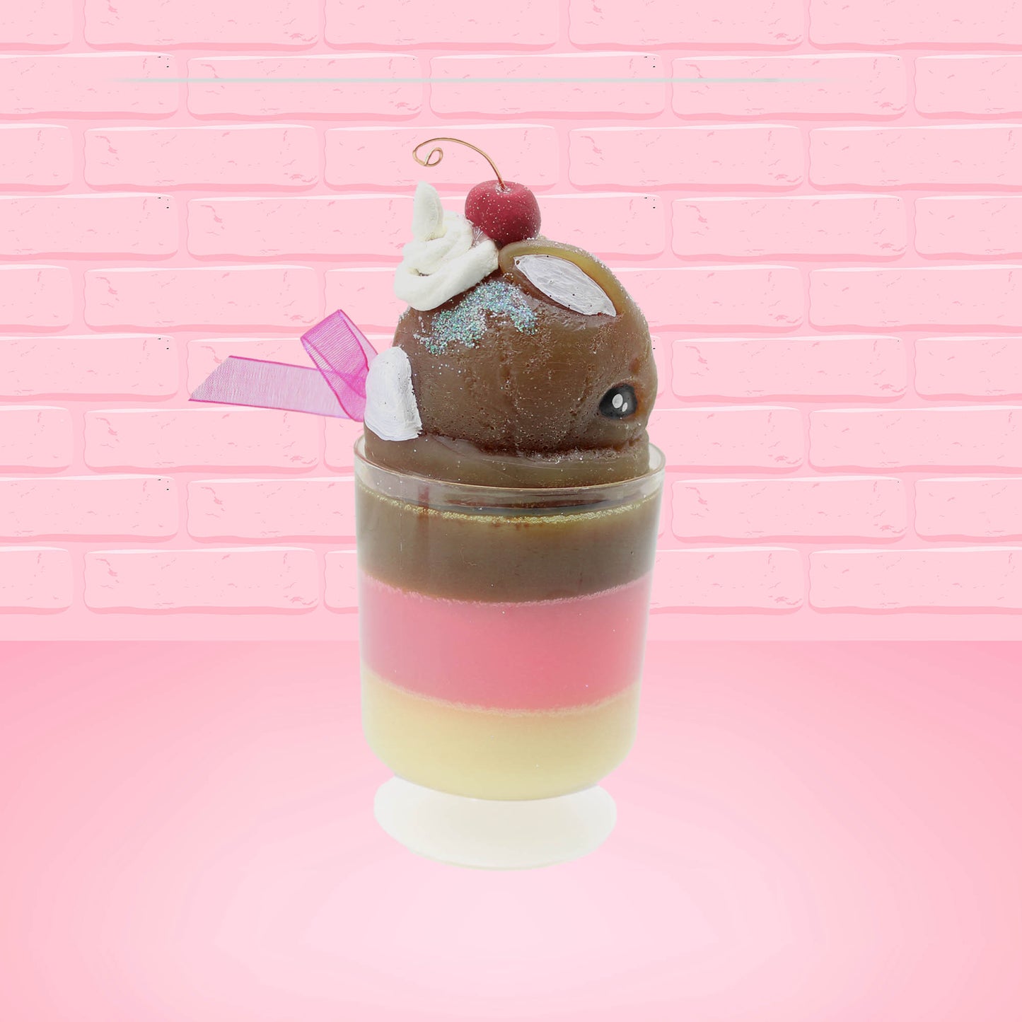 Cute Kawaii bunny tall Neapolitan three layered ice cream sundae with a cherry and swirl of whipped cream on top.  The top of the bunny is covered with white glitter, and has a pink bow.  This view is from the other side.