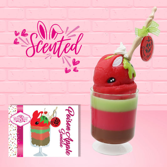 Cute kawaii bunny tall red green and brown ice cream sundae with green glaze and a swirl of whipped cream up top. In the top of the bunny is a bony finger with the poison apple acrylic keychain attached to it. The front of the character card is shown as well as the word scented.