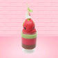 Cute kawaii bunny tall red green and brown ice cream sundae with green glaze and a swirl of whipped cream up top. In the top of the bunny is a bony finger with the poison apple acrylic keychain attached to it. This view is from the front.