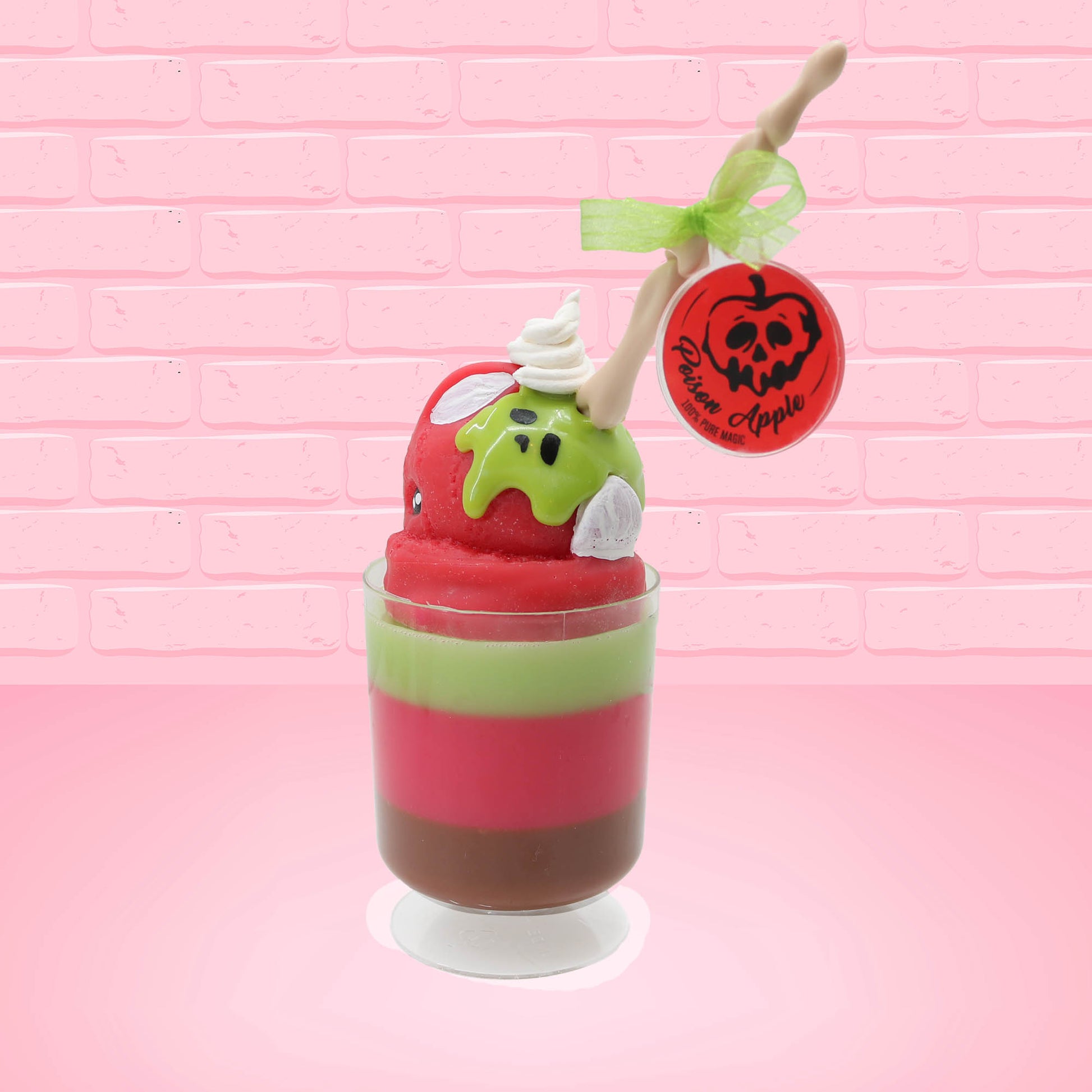 Cute kawaii bunny tall red green and brown ice cream sundae with green glaze and a swirl of whipped cream up top. In the top of the bunny is a bony finger with the poison apple acrylic keychain attached to it. This view is from the back at an angle.