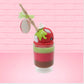 Cute kawaii bunny tall red green and brown ice cream sundae with green glaze and a swirl of whipped cream up top. In the top of the bunny is a bony finger with the poison apple acrylic keychain attached to it. This view is from the back at a different angle.