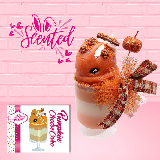 Cute kawaii bunny orange ice cream tall sundae that has orange tulle, a fall colored bow with a pumpkin in the middle, brown pecan halves, cinnamon twig on the whipped cream on top, and a glittery pumpkin stuck into the dish. The front of the character card is shown as well as the word scented.