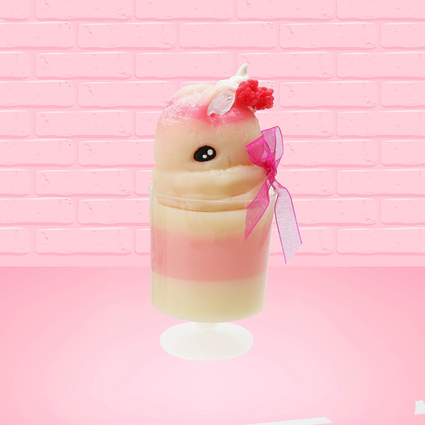 Cute kawaii bunny Raspberry Cheesecake white tall sundae with raspberries and a whipped cream swirl on top and a pink bow on the side. The bunny has glittery pink ears. This view is from the side at an angle. 
