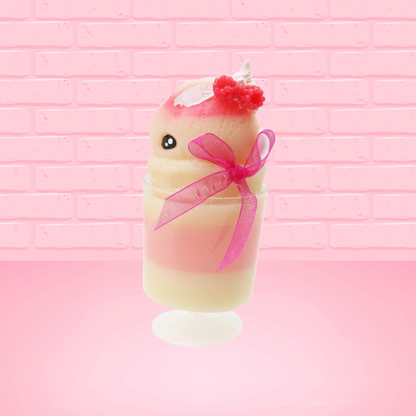 Cute kawaii bunny Raspberry Cheesecake white tall sundae with raspberries and a whipped cream swirl on top and a pink bow on the side. The bunny has glittery pink ears. This view is from the side.