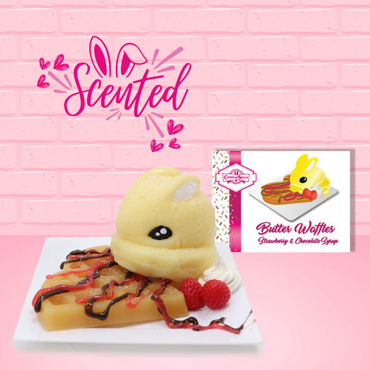 Cute kawaii butter bunny on top of a waffle with chocolate and red drizzles, strawberries, and on a square plate. The front of the character card and the word scented are shown.