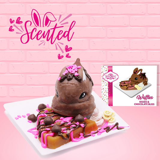 Cute kawaii brown bunny on top of a waffle with hot pink and chocolate drizzles, heart sprinkles, chocolate drops, and banana slices on top of a square plate. The front of the character card and the word scented is shown.