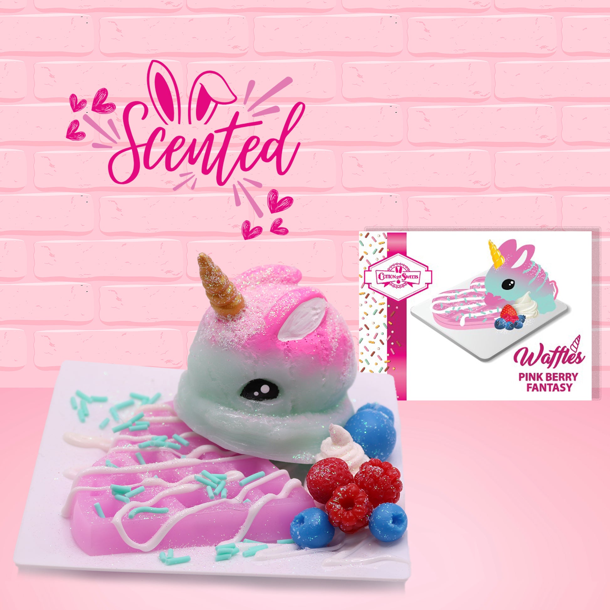 Cute kawaii blue and pink bunny unicorn on top of a pink waffle with white drizzle and blue sprinkles on top of a square plate. Red raspberries and blueberries are on the plate as well. The front of the character card is shown as well as the word scented. 