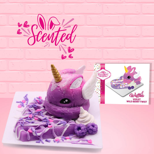 Cute kawaii purple unicorn bunny with white wings covered in white glitter, pink and purple drizzle and sprinkles, and purple raspberries on top of a square plate. The front of the character card is shown as well as the word scented.