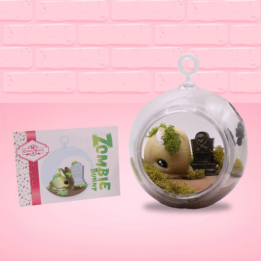 The front of the character card is shown, with the digital artwork showing the bunny in a terrarium with moss and a tombstone.